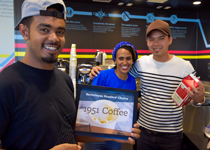 Three 1951 Coffee Company employees hold up a certificate for the Berkel