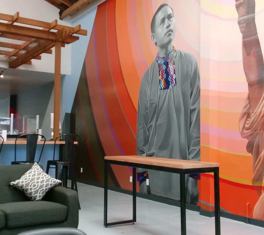 The interior of the 1951 Coffee Co. in Oakland, featuring a sofa, bar counter and large mural.