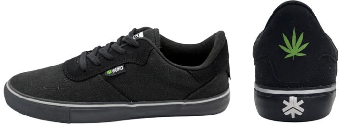 Sneakers made from hemp by Etiko. A side and back view of the low-top shoes that are black in color with an image of a hemp leaf and the Etiko logo on the back and a small Etiko label on the side..