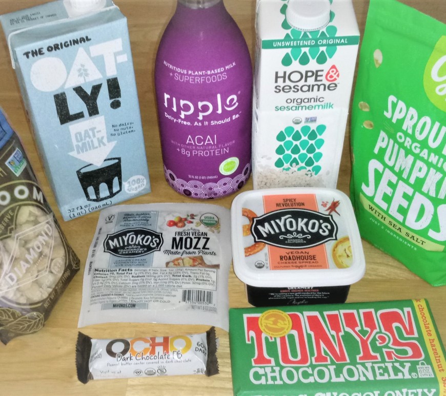 Ethical Review of the Grocery Outlet. Items purchased recently, including plant-based milk from Oatley, Ripple, and Hope & Sesame; marcona almonds and spouted pumpkin seeds, vegan mozzarella and cheese spread from Miyoko's, and chocolate from Tony's Chocolonely and OCHO.