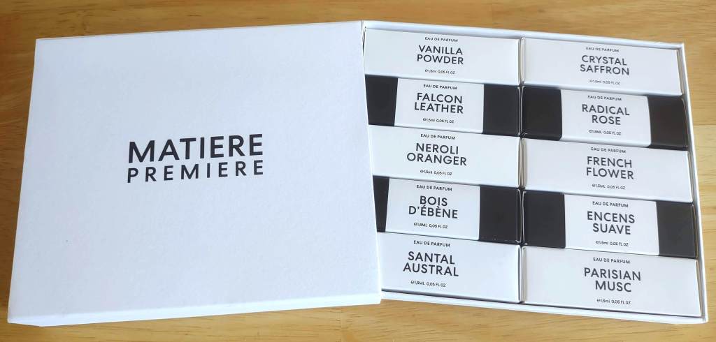 A photo of the Matiere Premiere discovery set, opened to reveal 10 small boxes each labeled with a perfume name, from Vanilla Powder to Parisian Musc.