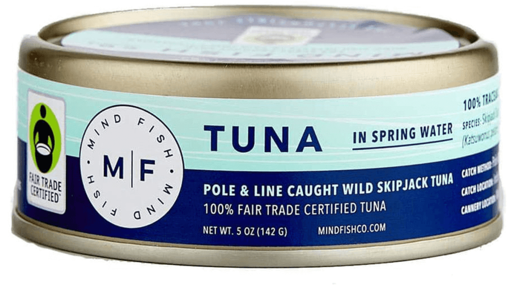 A can of Fair Trade certified tuna from the Mind Fish Co., Maldives is shown. the side view of the can contains the Fair Trade Certified logo and the message that the wild skipjack tuna is pole and line caught.
