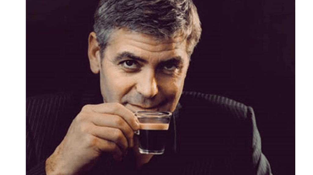 A photo of George Clooney holding an espresso from an advertisement for Nespresso, which is now a certified B Corporation.